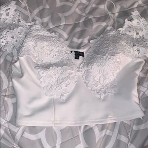 White crop top with lace print.
